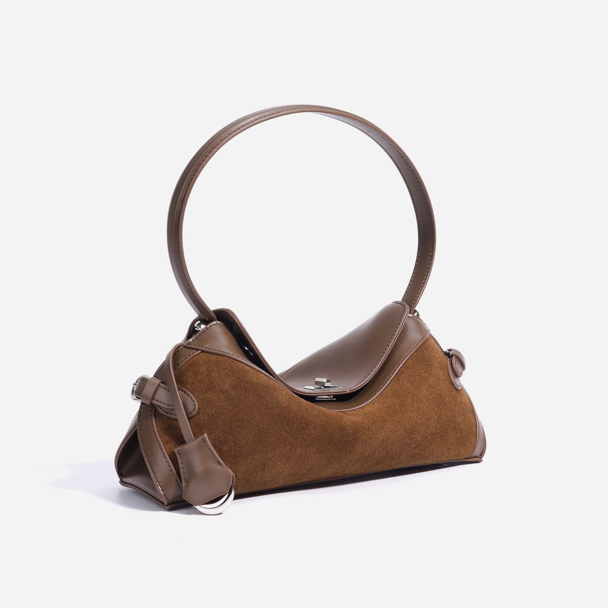 Light brown handbag in suede and leather, side angle showing circular handle.